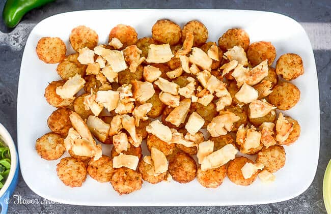 Chicken Alfredo Italian Totchos, inspired by the Italian style nachos at one of our favorite restaurants, use tater tots instead of tortilla or pasta chips to make a quick and easy, kid-friendly weeknight meal.