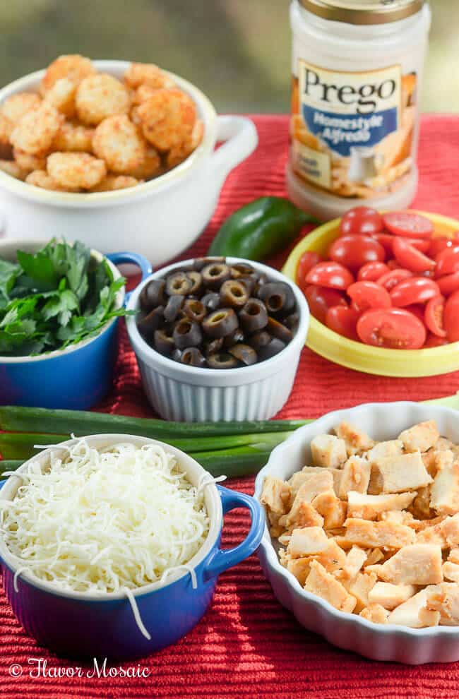 Chicken Alfredo Italian Totchos, inspired by the Italian style nachos at one of our favorite restaurants, use tater tots instead of tortilla or pasta chips to make a quick and easy, kid-friendly weeknight meal.