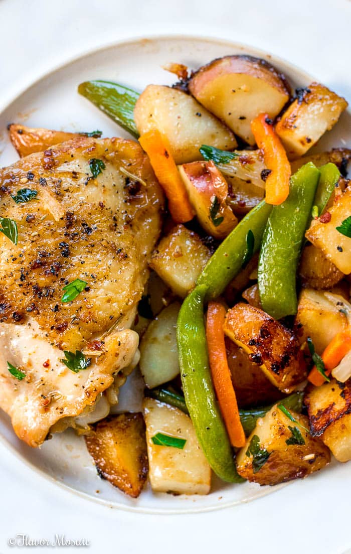 Chicken Vesuvio - an Italian-American chicken dinner in a skillet with potatoes, garlic, snap peas and carrots. It is popular in Chicago.
