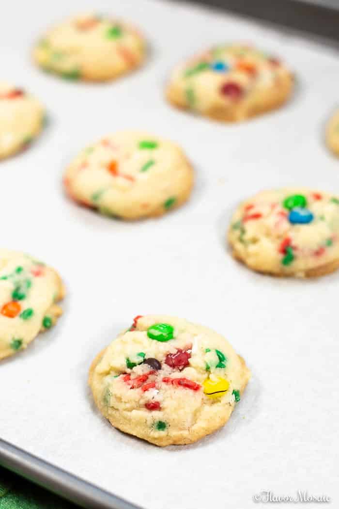 Baked Confetti M&M Cookies on parchment covered cookie sheet