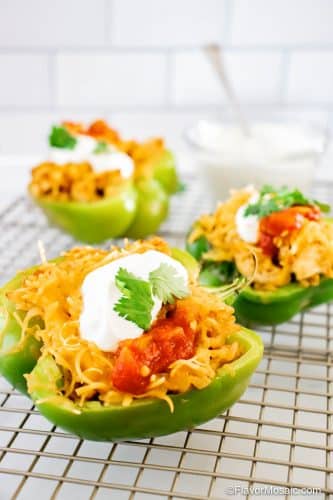 3 Chicken Fajita Stuffed Peppers on wire rack with with tile background.
