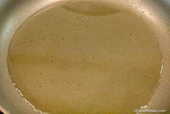 View of oil covering the bottom of a skillet.
