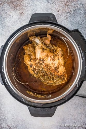 Overhead view of seasoned turkey breast after pressure cooking.
