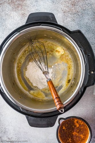 Overhead view of adding flour to the butter in the Instant Pot.
