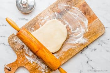 rolling out empanada dough