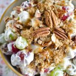 Close up photo of grape salad topped with brown sugar and pecans