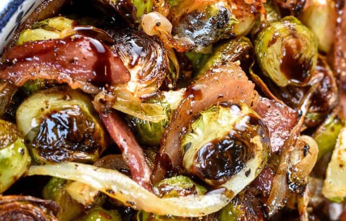 Horizontal close up photo of roasted brussels sprouts with bacon and balsamic