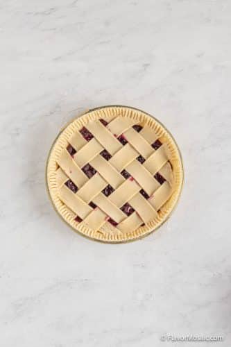 Overhead view of a blueberry pie with a lattice pie crust.