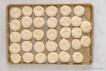 Place the biscuits onto a large well greased baking sheet with a lip or 2 medium sized baking sheets.