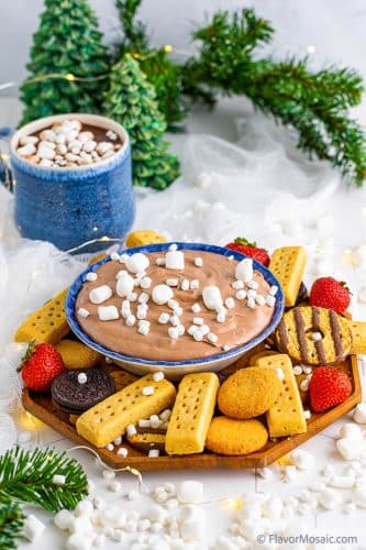 Platter of cookies and strawberries surrounding a bowl of Hot Chocolate Dip topped with mini marshmallows.
