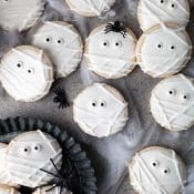 Iced sugar cookies with royal icing and candy eyeballs to look like mummy cookies.