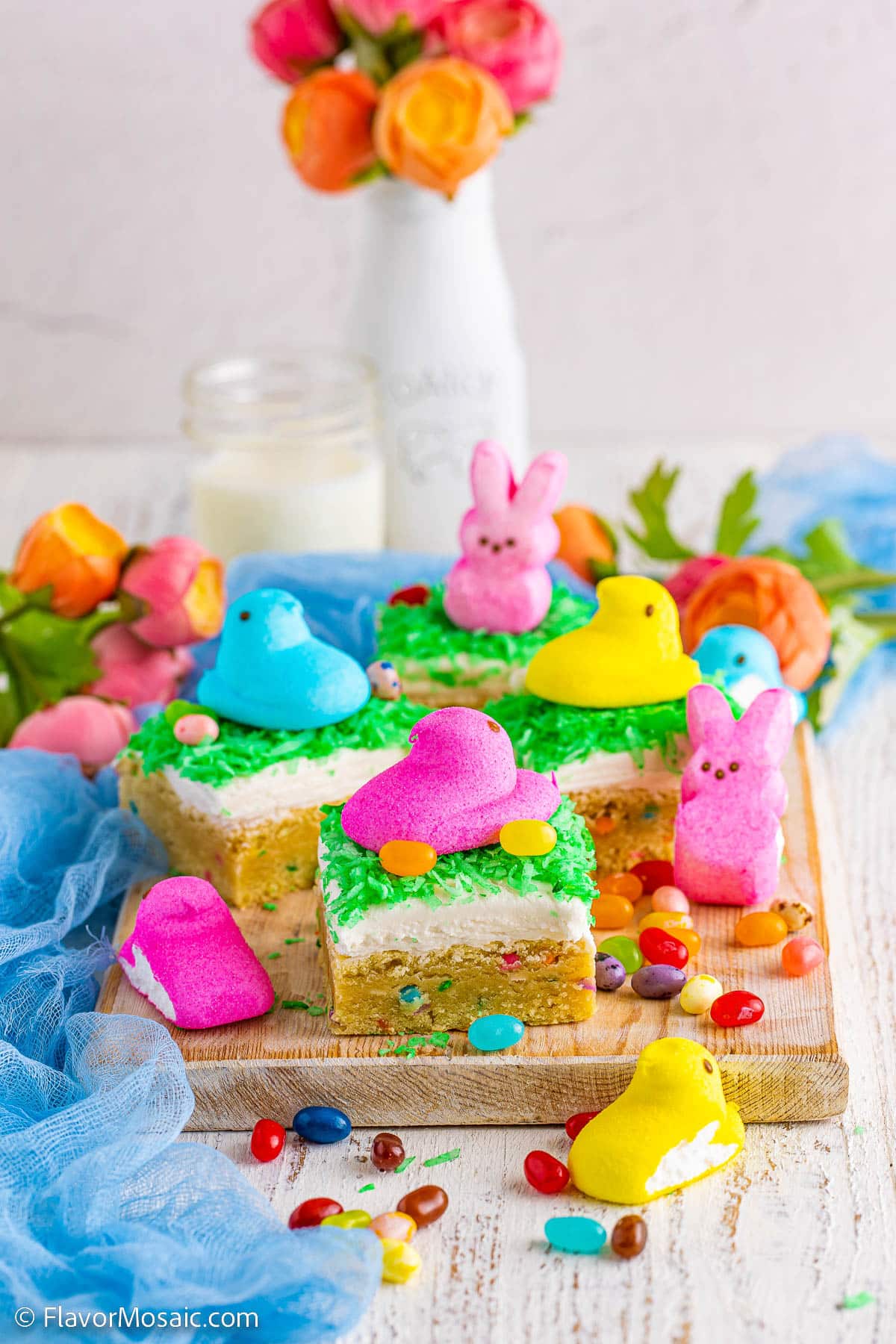 Side view of multiple Easter Sugar Cookie Bars topped with pink blue and yellow Easter Peeps.