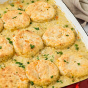 Creamed Chicken and Biscuit Casserole in a red casserole dish.