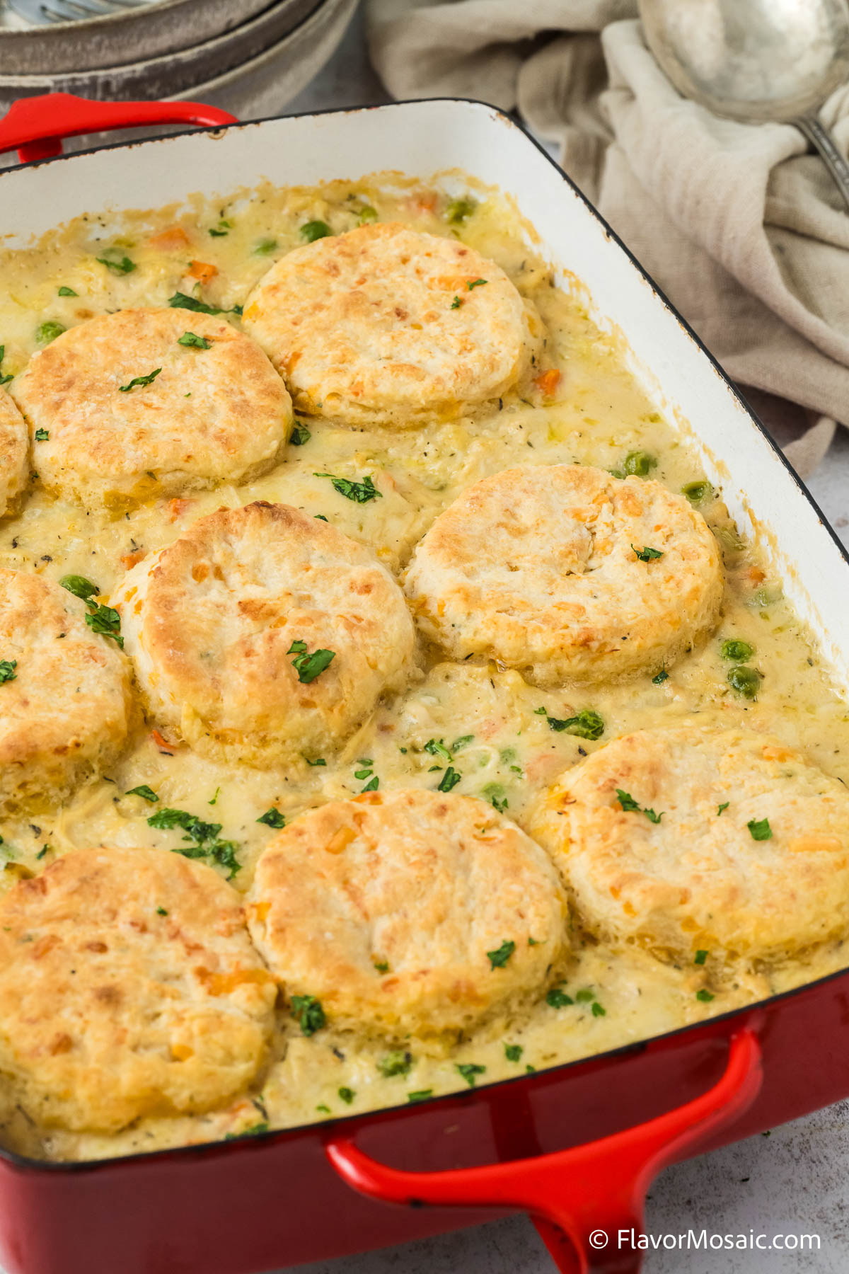 Partial view of the top of a whole creamed chicken and biscuit casserole.